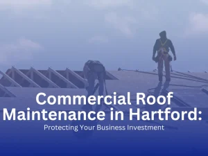 Commercial roofers in safety harnesses working on a flat roof in Hartford, Connecticut